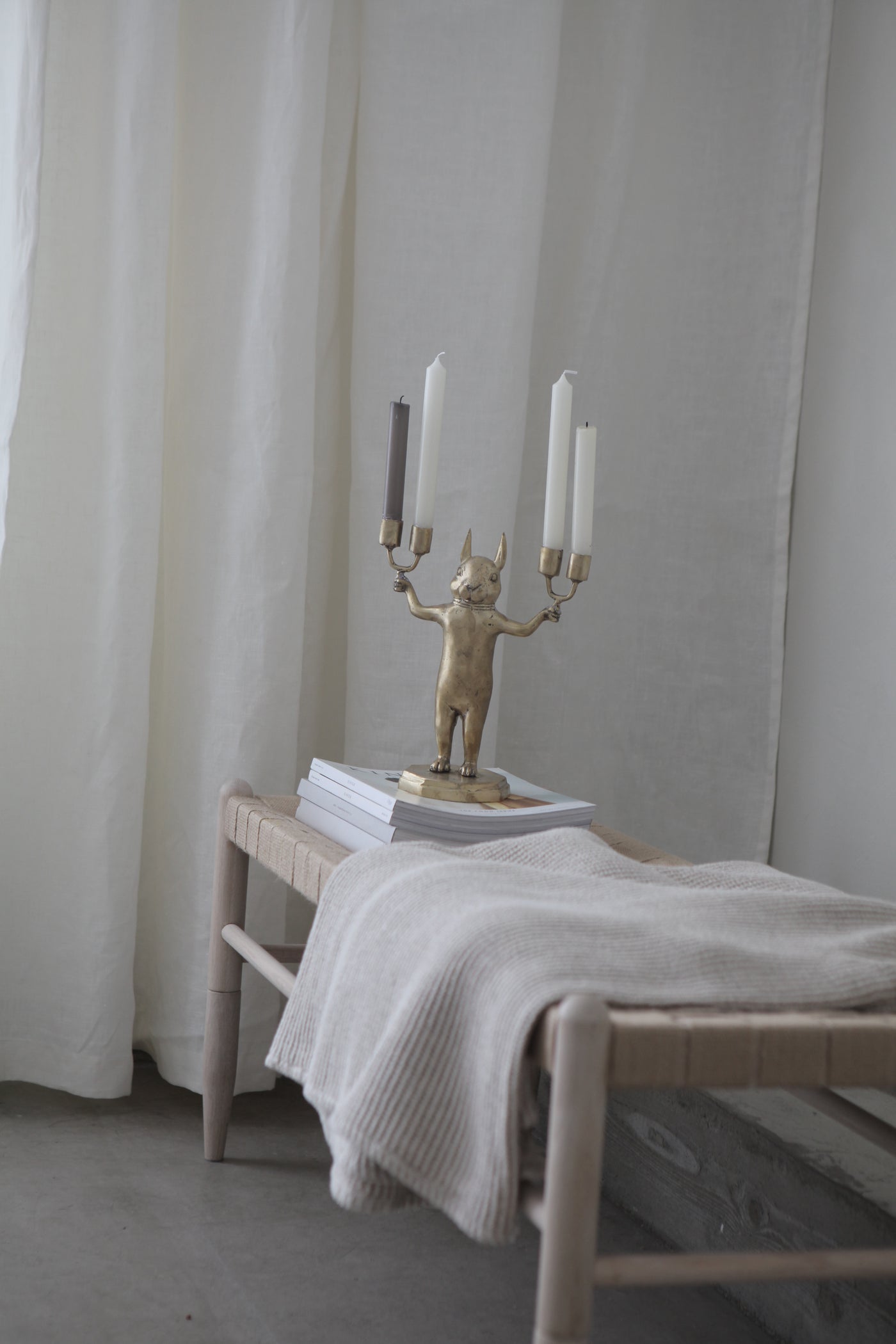 Chipmunk Candle Holder in Brass with four candles on bench
