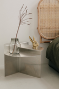 BUNNY Tealight Holder in brass next to Rattan headboard