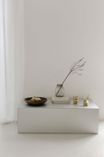 BUNNY Tealight Holder with patina finish on table with interior details