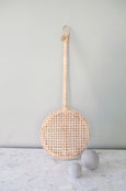 Carpet Beater artwork in natural Rattan on table