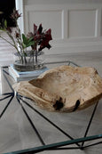 Carved Wood Bowl on glass table with flowers in vase