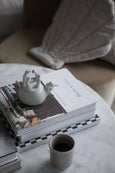 Sleepy Animals white Rhino on stack of books