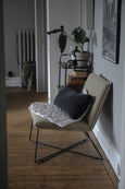 Shell Mattress Medium on beige chair with pillow