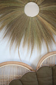 Close-up on Grass Straw Mirror with Rattan Headboard