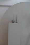 The Straw Concrete Candle Globes on white pedestal