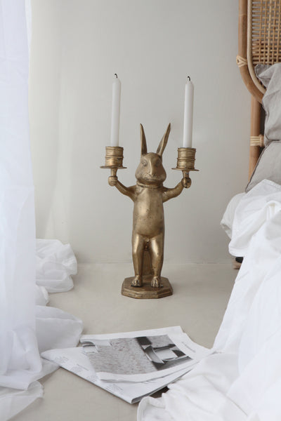 The Straw Rabbit Candle Holder in Brass on floor