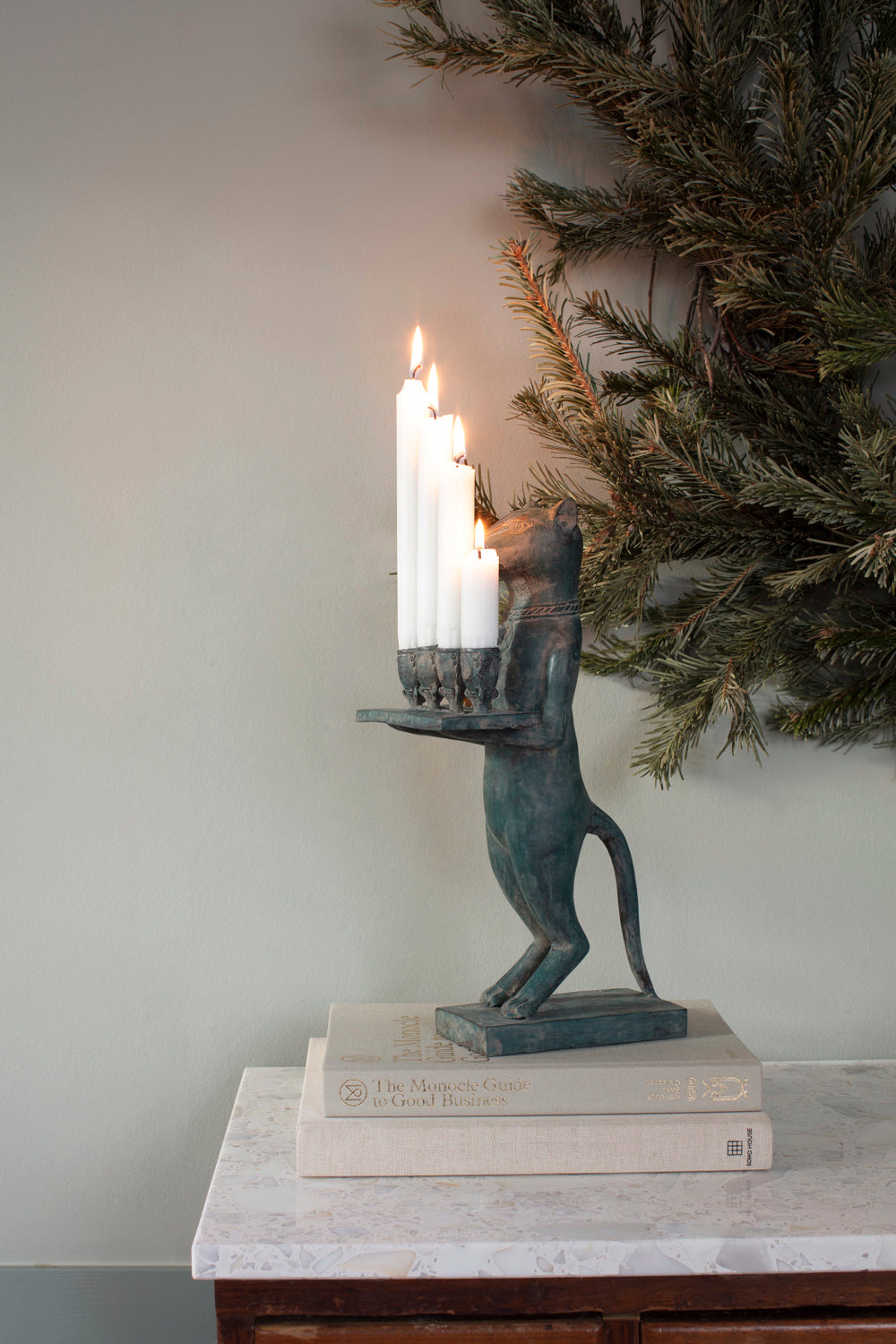 Otto the Candle Holder in dark bronze with four burning candles