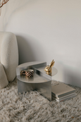 BUNNY Tealight Holder in brass on metal table next to cup
