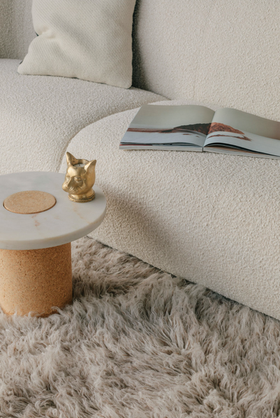 CAT Tealight Holder in brass on table with open book 